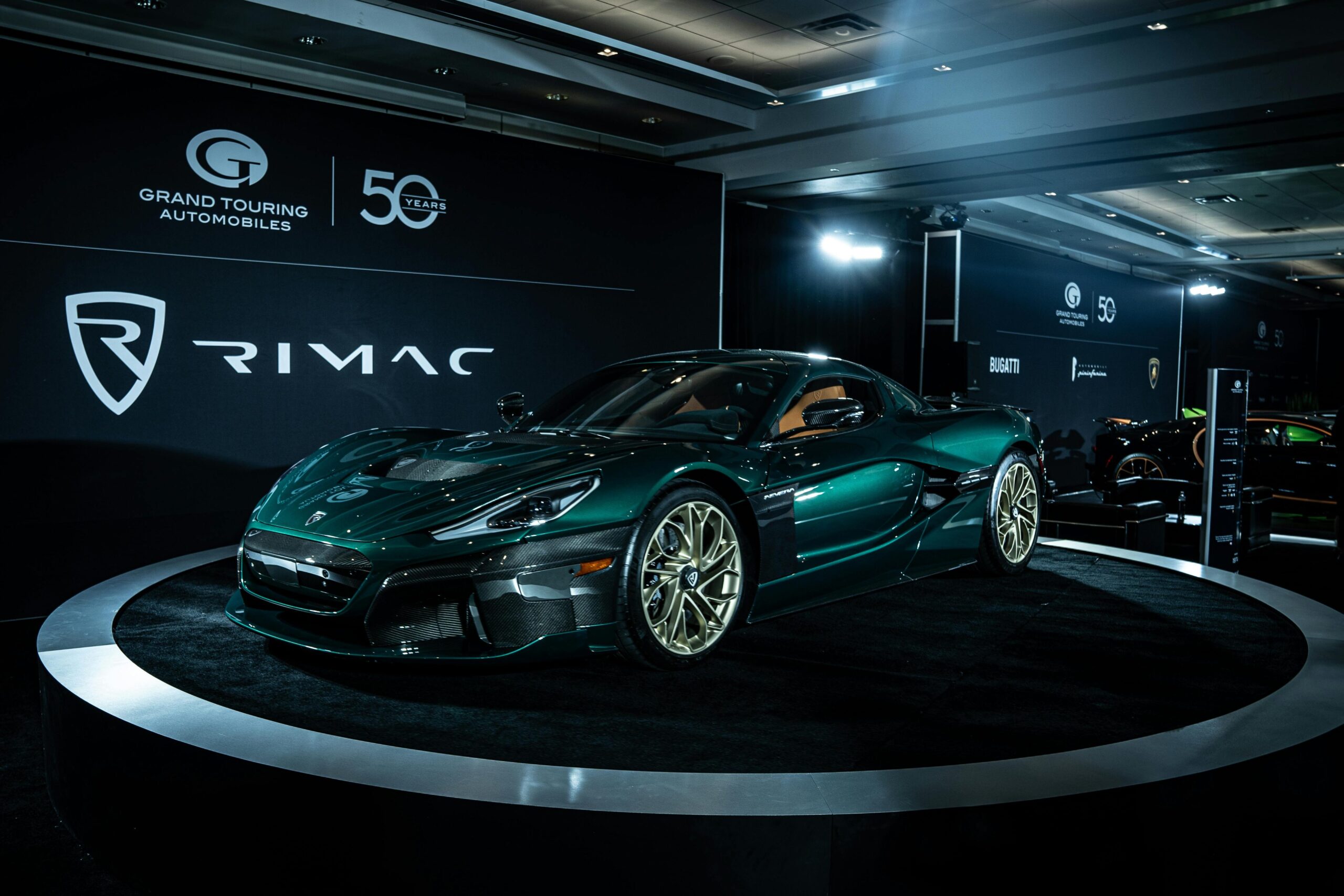 A Rimac electric sports car on display at an automotive event, showcasing sleek design and innovation.